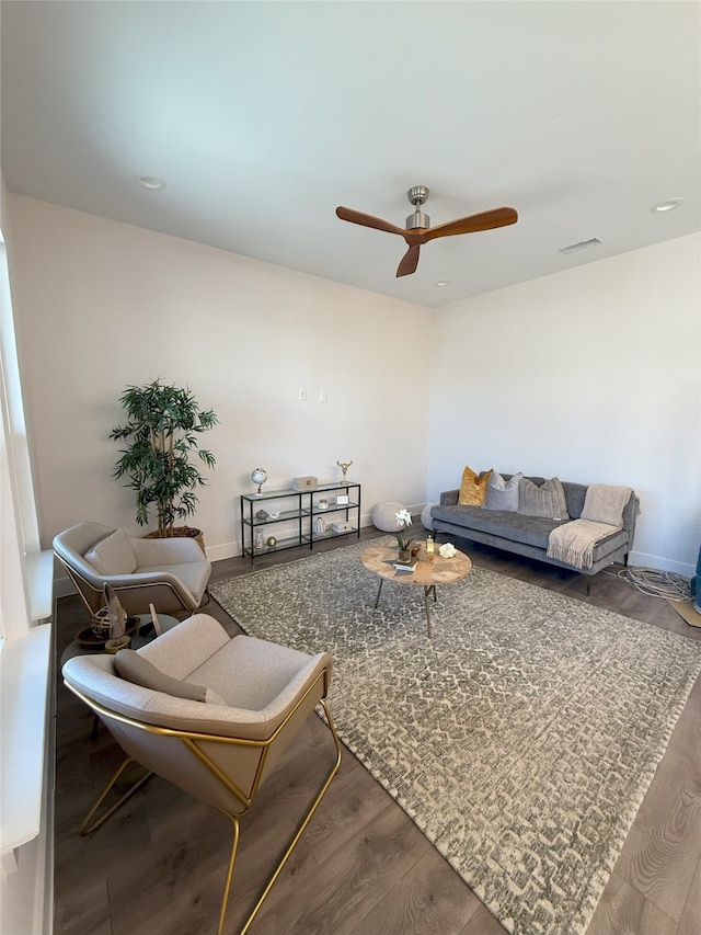 living room featuring ceiling fan and hardwood / wood-style floors