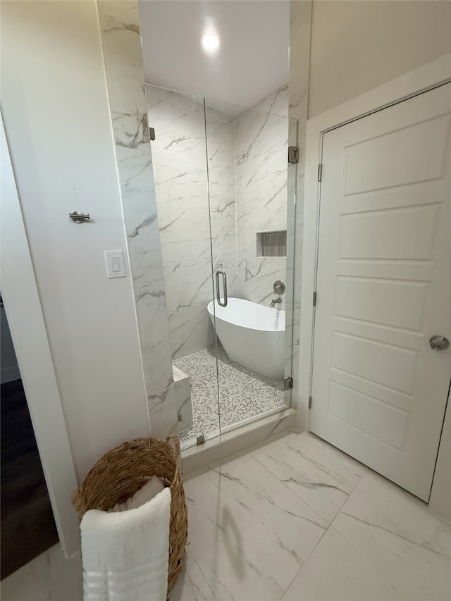 bathroom featuring shower with separate bathtub