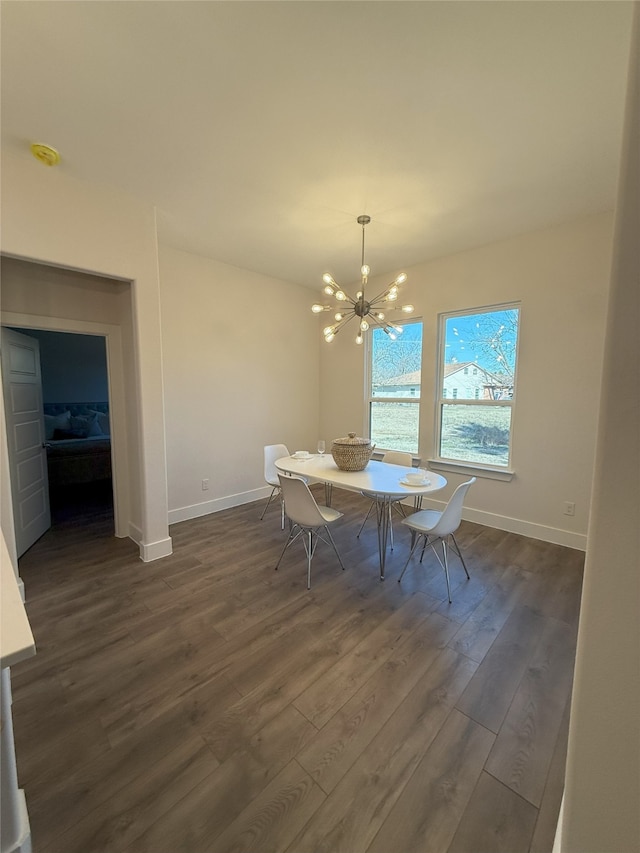 dining space with an inviting chandelier and dark wood-type flooring