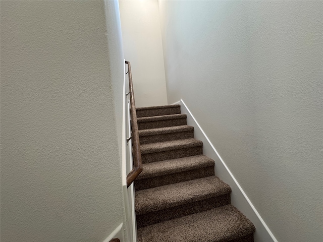 hall featuring dark colored carpet