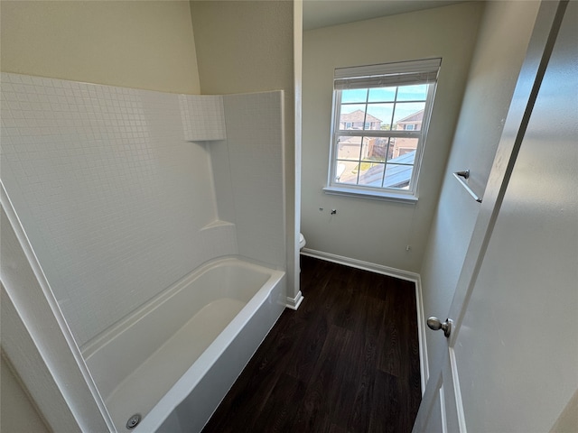 unfurnished bedroom with ceiling fan, dark carpet, a spacious closet, and a closet