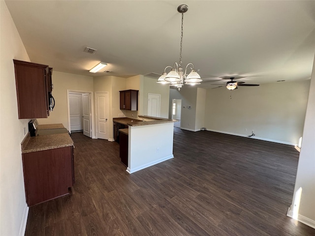 kitchen with pendant lighting, stove, dark wood-type flooring, ceiling fan with notable chandelier, and dark brown cabinets