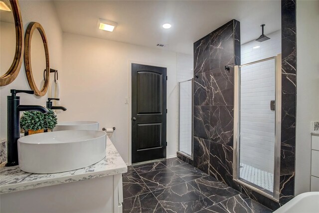 bathroom featuring vanity and a tile shower