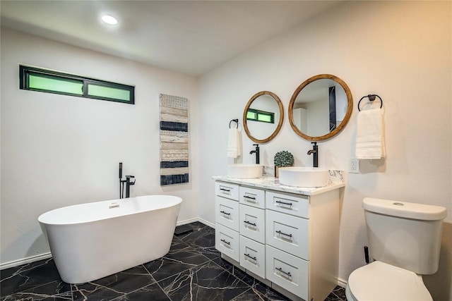 bathroom with vanity, toilet, and a bathtub