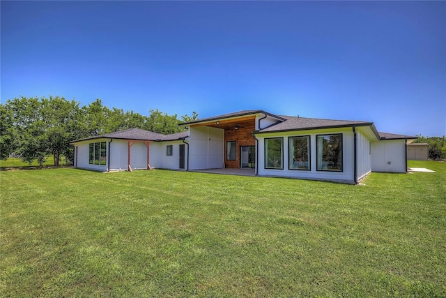 back of property featuring a patio and a lawn