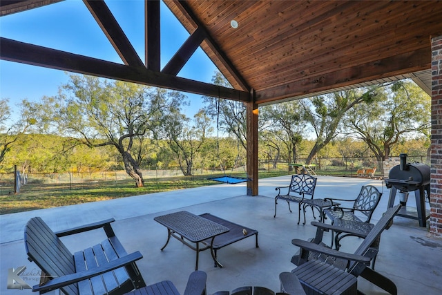 view of patio featuring area for grilling and tennis court