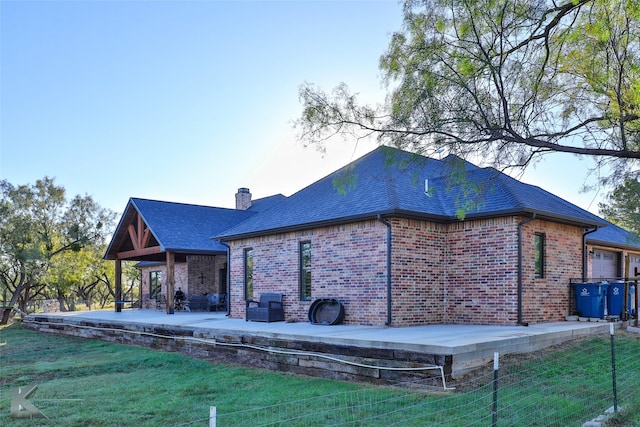 rear view of house featuring a yard and a patio area