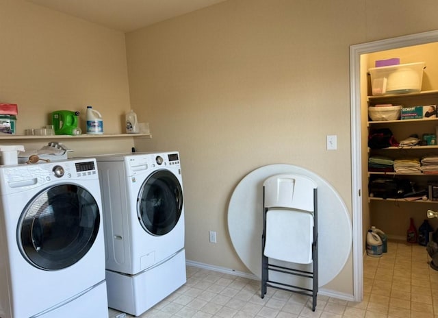 clothes washing area with washer and clothes dryer