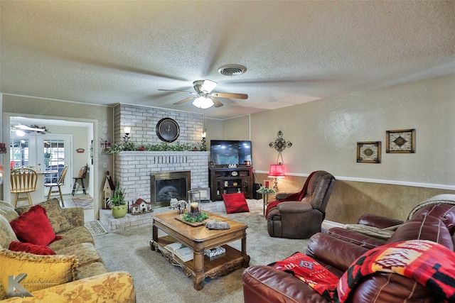 carpeted living room with a fireplace, a textured ceiling, and ceiling fan