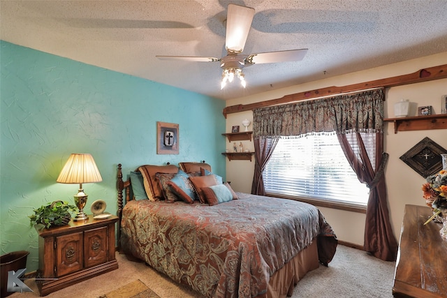 bedroom with ceiling fan, light colored carpet, and a textured ceiling