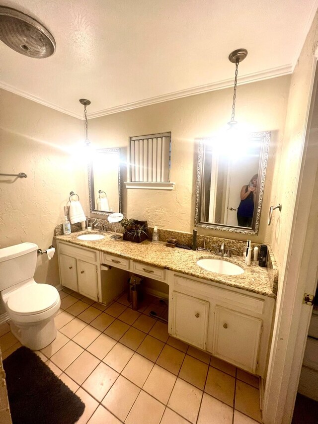 bathroom with tile patterned flooring, vanity, toilet, and ornamental molding