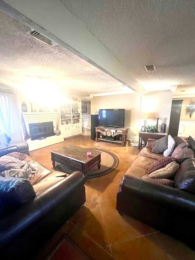 living room featuring tile patterned flooring and a textured ceiling