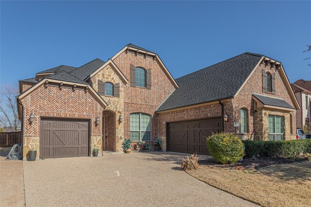 view of front of property featuring a front lawn and a garage