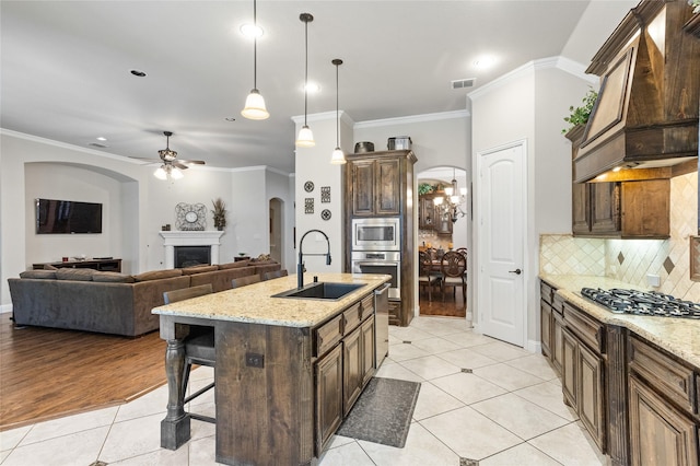 804 Colby Dr, Mansfield, TX 76063 - kitchen featuring stainless steel appliances, a sink, custom range hood, light tile patterned floors, and a ceiling fan