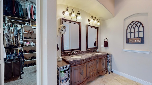 804 Colby Dr, Mansfield, TX 76063 - full bath with double vanity, baseboards, tile patterned flooring, and a walk in closet