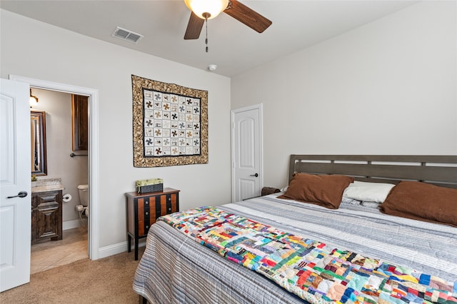 carpeted bedroom featuring ceiling fan and ensuite bathroom