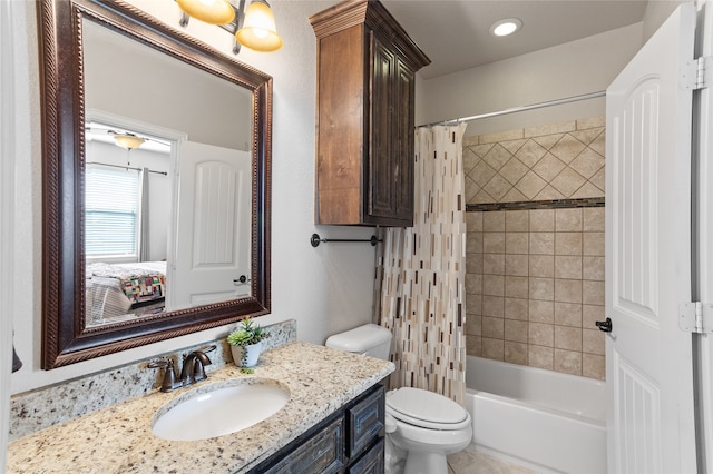 full bathroom with shower / tub combo with curtain, vanity, and toilet