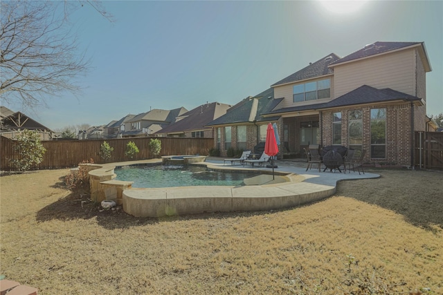 view of swimming pool featuring a yard and a patio area