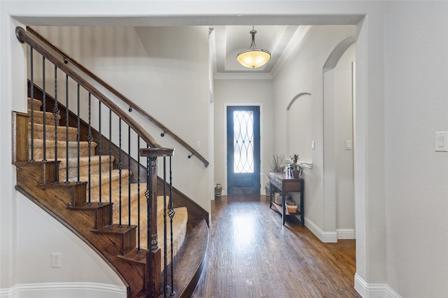 entryway featuring crown molding and dark hardwood / wood-style flooring