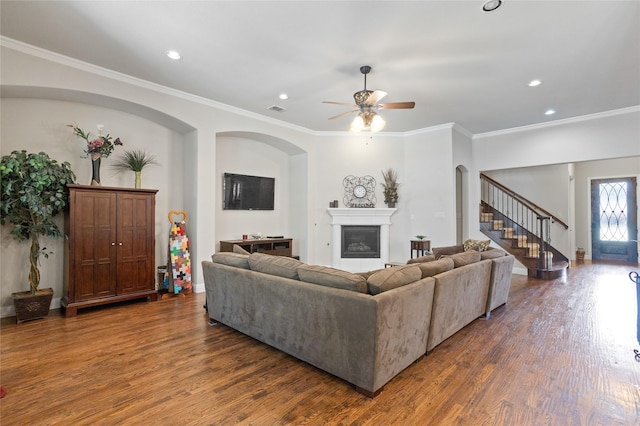 living room featuring crown molding, ceiling fan, and dark hardwood / wood-style flooring