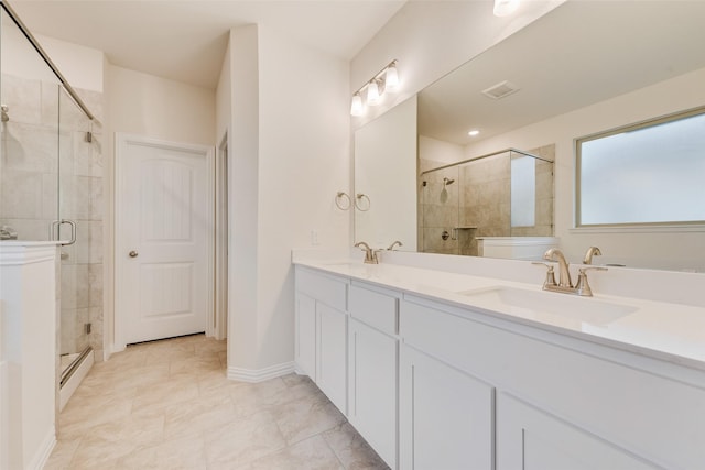 full bath featuring double vanity, a sink, and a shower stall