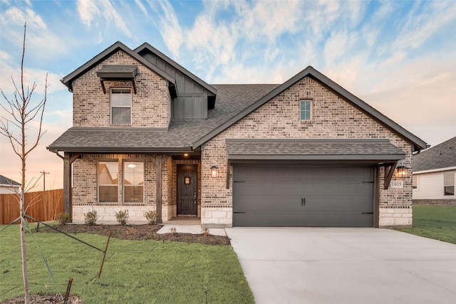 view of front of house featuring a front yard, concrete driveway, roof with shingles, and fence