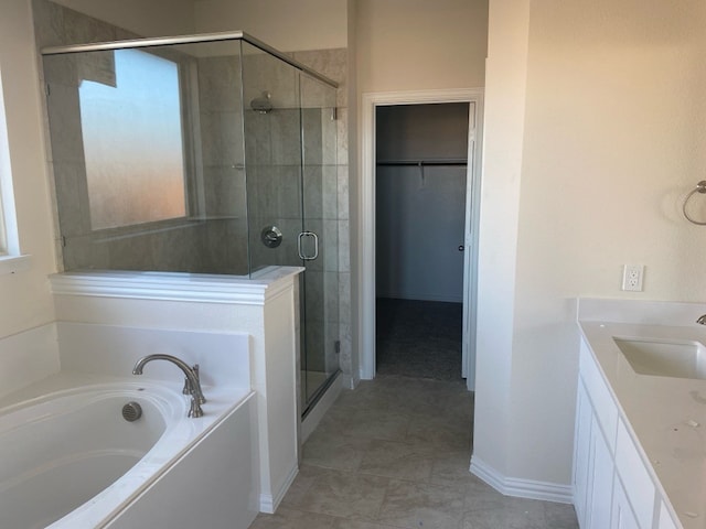 bathroom featuring tile patterned floors, vanity, and separate shower and tub