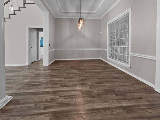 spare room featuring dark hardwood / wood-style floors and ornamental molding