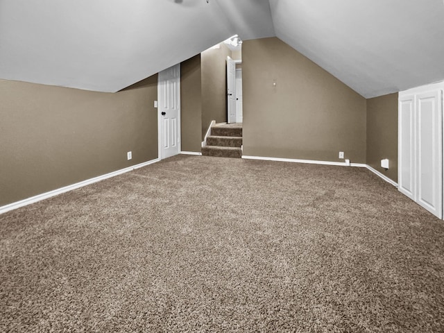 bonus room with carpet floors and vaulted ceiling