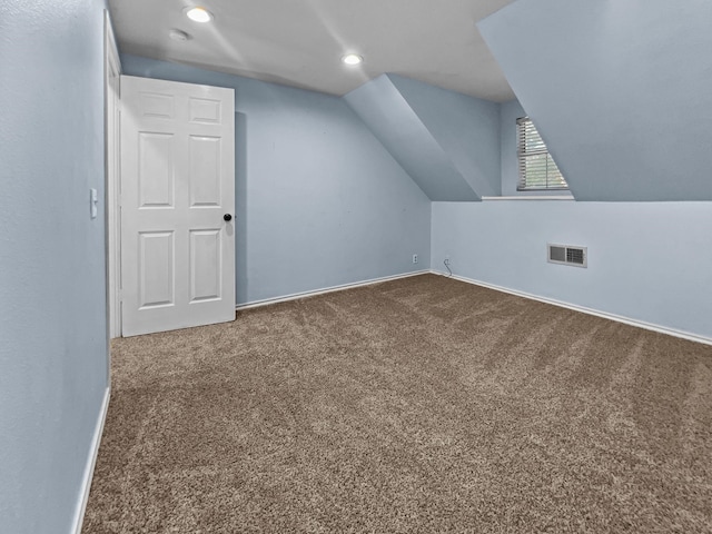 additional living space featuring carpet and lofted ceiling