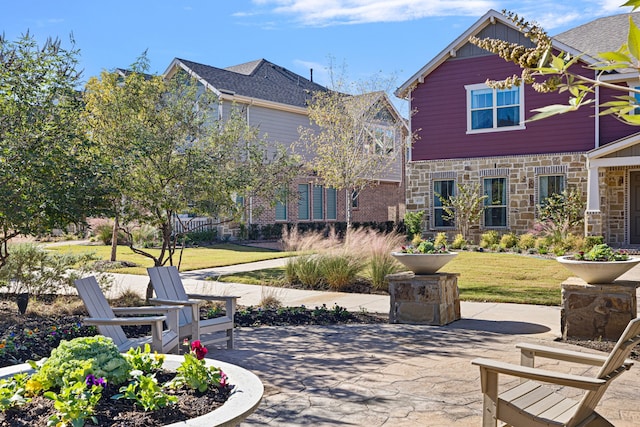 view of property's community with a patio area and a yard