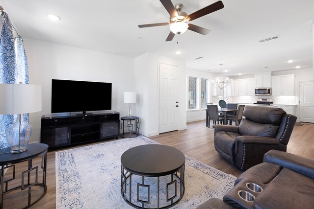 living room featuring ceiling fan and wood-type flooring