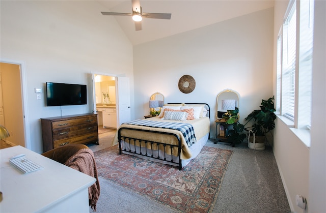 bedroom featuring carpet flooring, ensuite bathroom, high vaulted ceiling, and ceiling fan