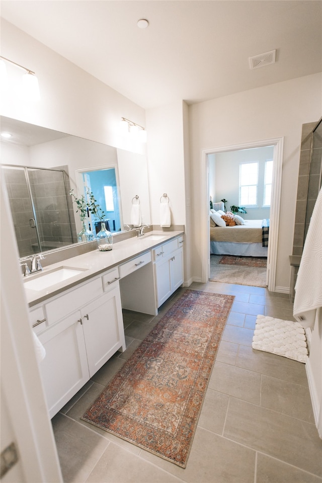 bathroom featuring tile patterned floors, vanity, and walk in shower