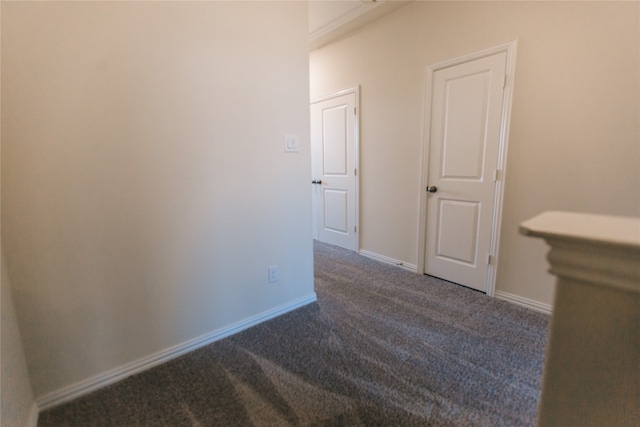 hallway with dark carpet