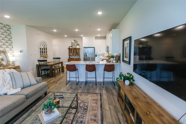 living room with sink and dark wood-type flooring