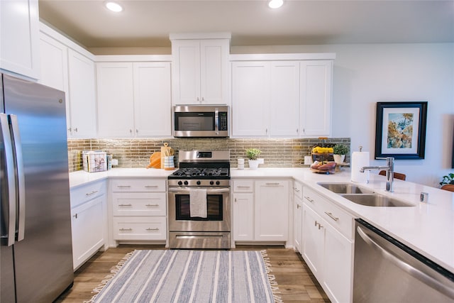 kitchen featuring dark hardwood / wood-style floors, white cabinetry, sink, and appliances with stainless steel finishes