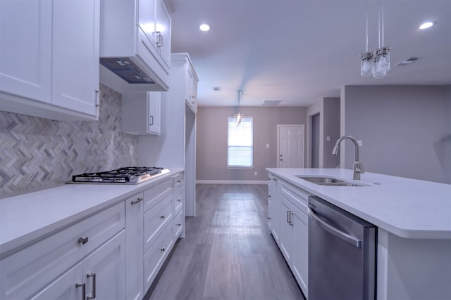 kitchen featuring a center island with sink, white cabinets, stainless steel appliances, and sink