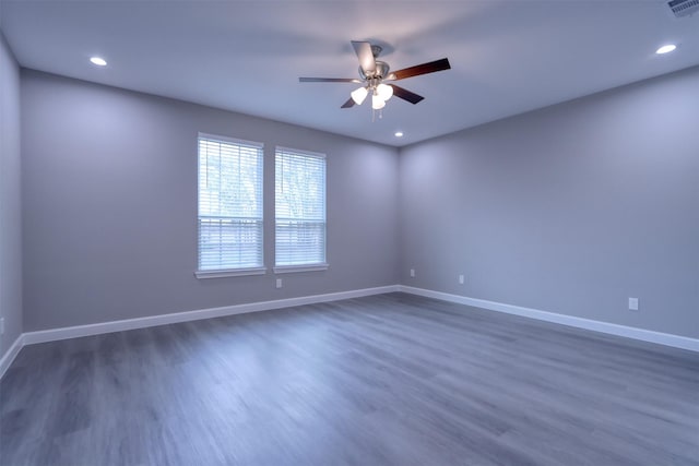 spare room featuring dark wood-style floors, recessed lighting, a ceiling fan, and baseboards
