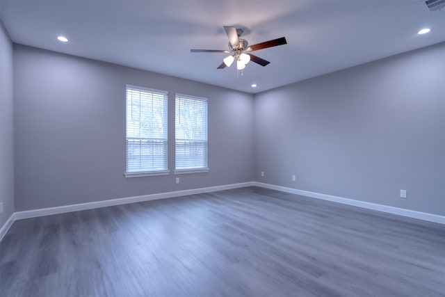 empty room with hardwood / wood-style flooring and ceiling fan