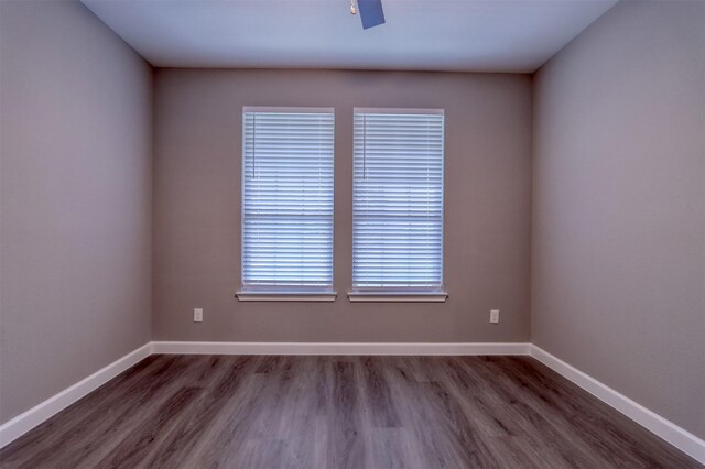 empty room featuring baseboards and wood finished floors