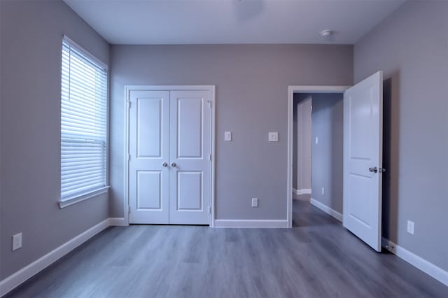 clothes washing area featuring hookup for an electric dryer and light hardwood / wood-style floors