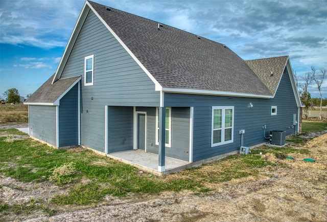 rear view of property with a patio and central AC