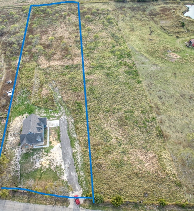 birds eye view of property featuring a rural view