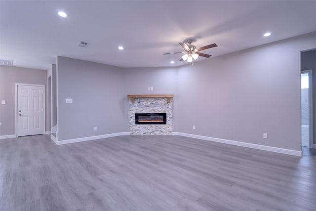 interior details featuring a fireplace and wood-type flooring