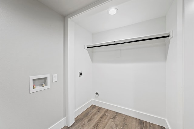 washroom featuring electric dryer hookup, hookup for a washing machine, and wood-type flooring