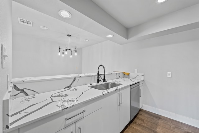 kitchen featuring white cabinetry, dark wood-type flooring, hanging light fixtures, an inviting chandelier, and stainless steel dishwasher