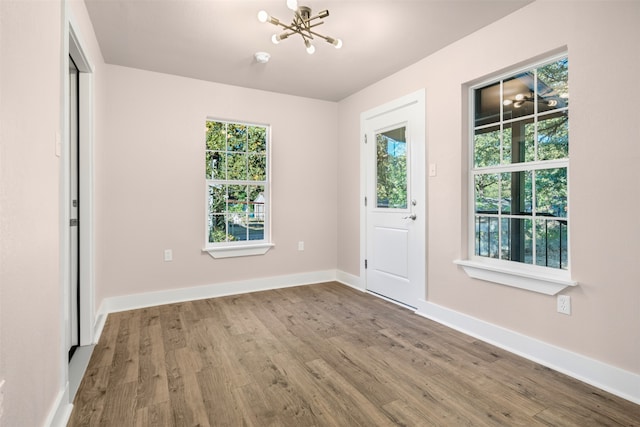 interior space featuring hardwood / wood-style floors and a notable chandelier