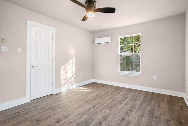 unfurnished room featuring an AC wall unit, ceiling fan, and dark hardwood / wood-style flooring