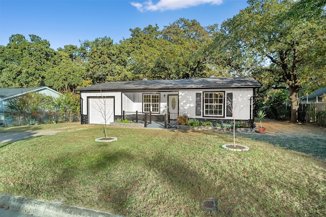 ranch-style house with a front yard, a porch, and a garage